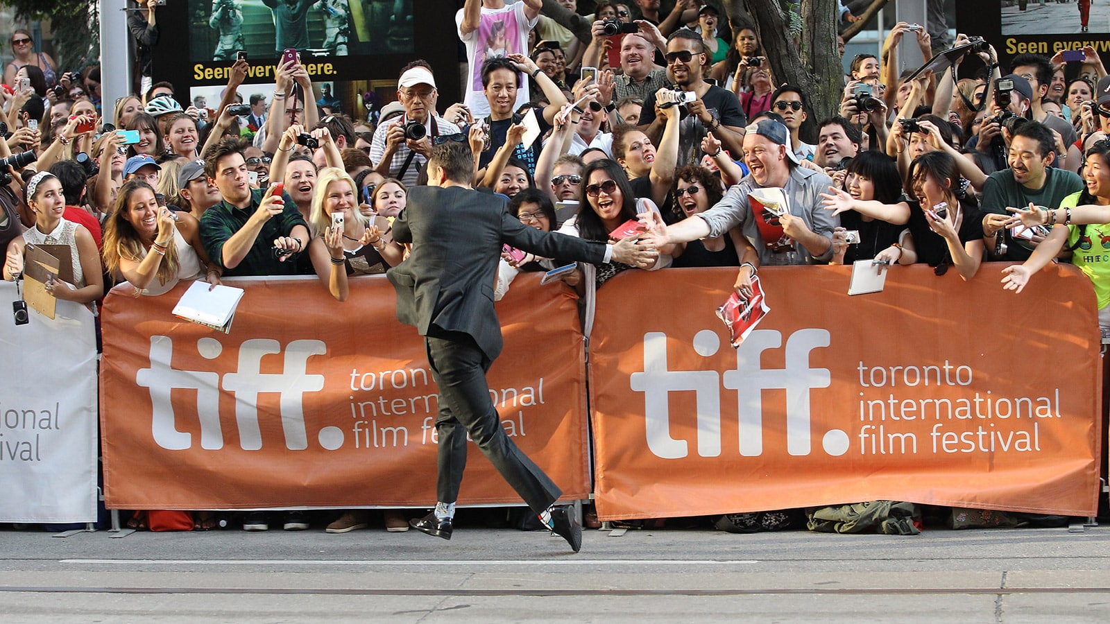 Joseph Gordon-Levitt runs to fans with special high fives at the "Don Jon" premiere